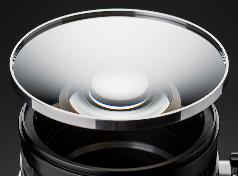 Close-up of a Newtonian reflector telescope parabolic mirror showing the reflective aluminum coating surface