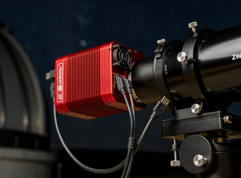 Cooled astronomy camera attached to telescope focuser with USB and power connections