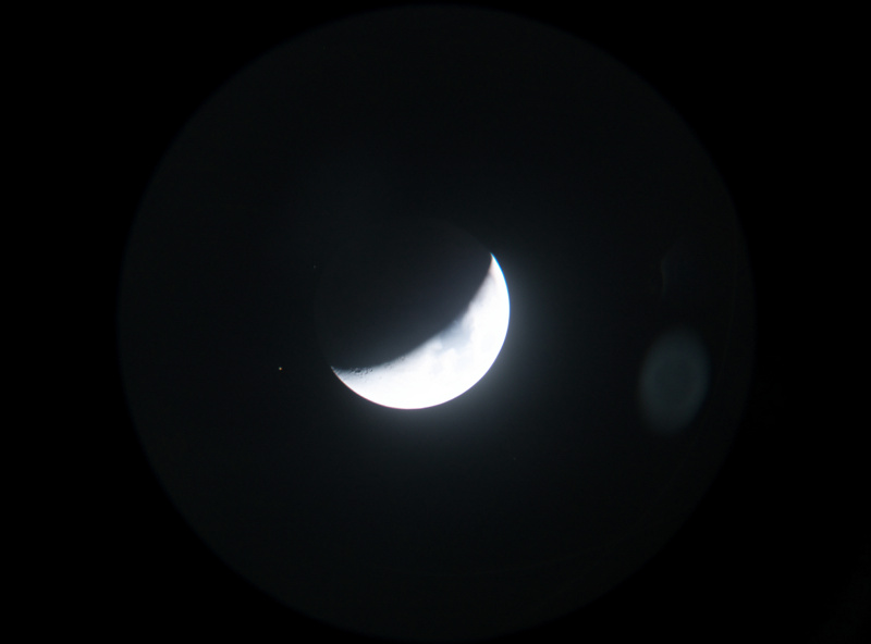 Venus showing thin crescent phase through telescope eyepiece