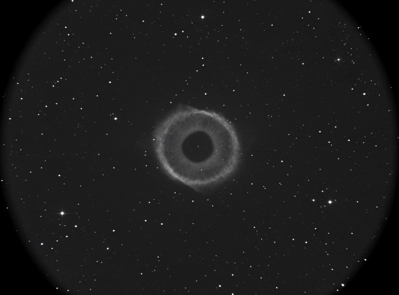 Ring Nebula M57 in Lyra appearing as a small gray smoke ring at high magnification