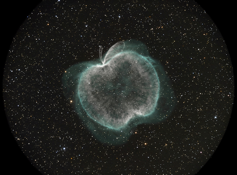 Dumbbell Nebula M27 showing its distinctive apple-core shape in a telescope eyepiece view