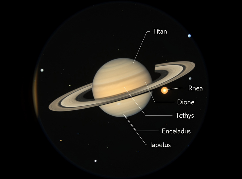 Saturn moon Titan visible near the planet