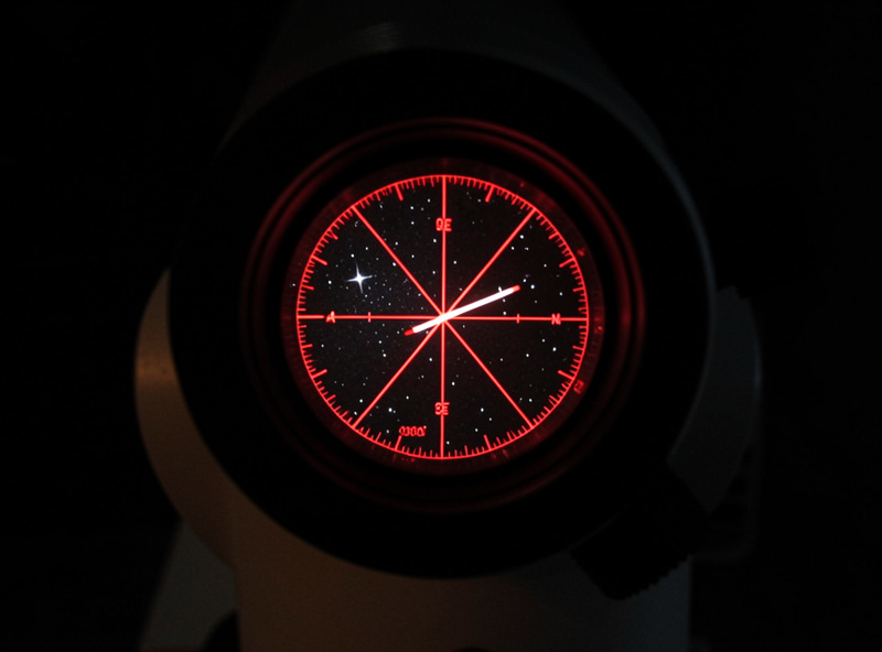 Close-up of an illuminated polar scope reticle showing the position of Polaris during polar alignment of an equatorial mount