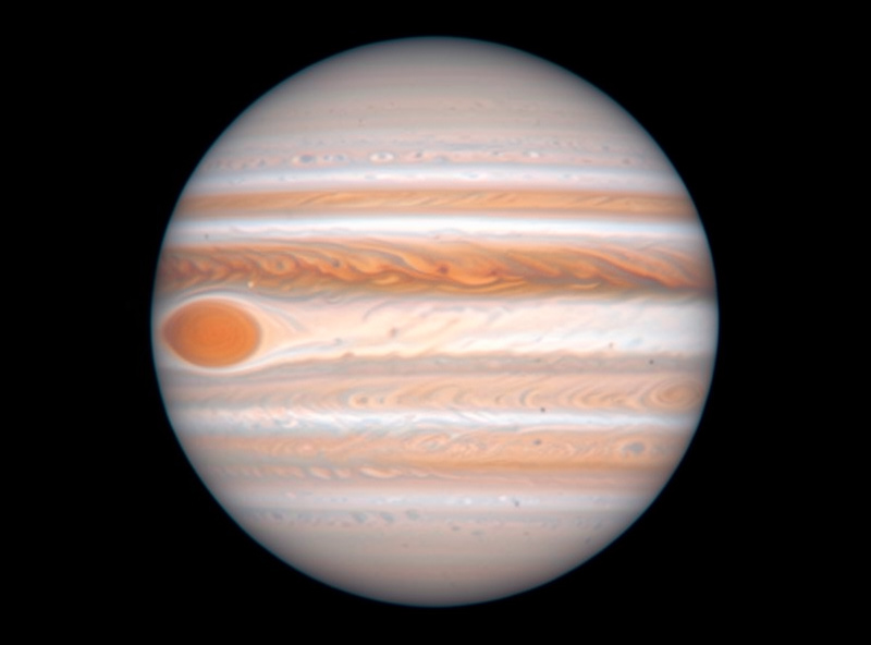 Jupiter with cloud bands and the Great Red Spot softened by atmospheric turbulence as seen through an eyepiece