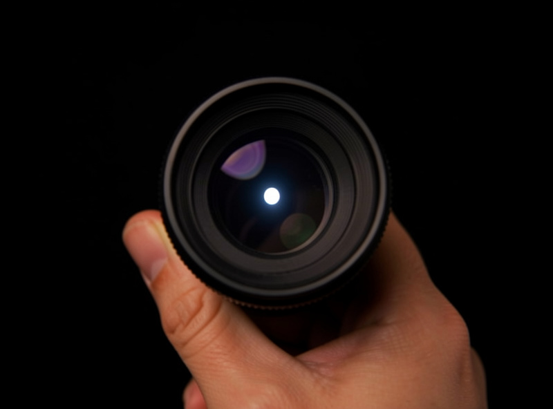 Close macro view of a telescope eyepiece showing the small bright circle of the exit pupil
