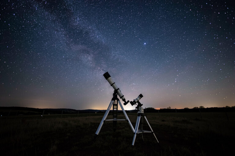 Telescope under a vast spring night sky at a dark rural site set up for an all-night Messier marathon