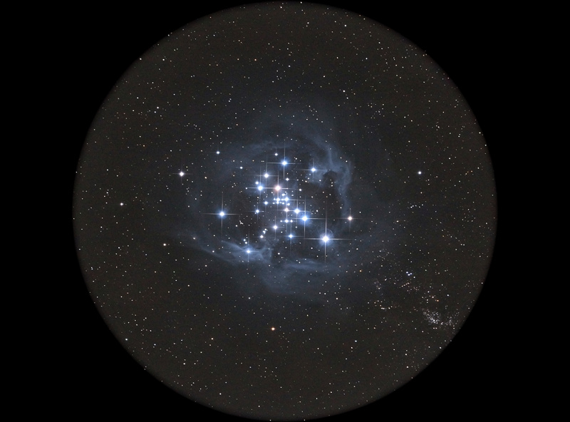 The Pleiades open star cluster framed in a wide binocular field of view against a dark sky